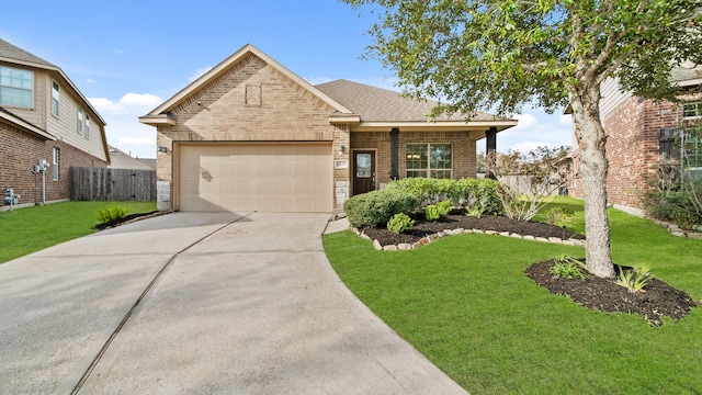 view of front of home with a front yard and a garage