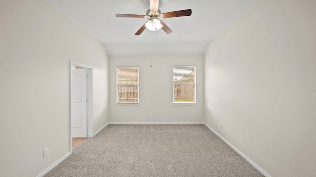 carpeted empty room featuring ceiling fan and vaulted ceiling