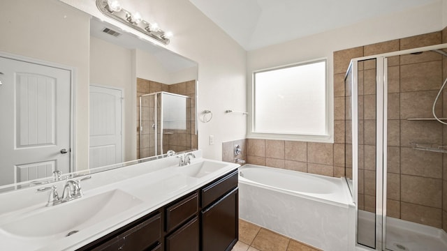 bathroom featuring tile patterned flooring, vanity, vaulted ceiling, and shower with separate bathtub