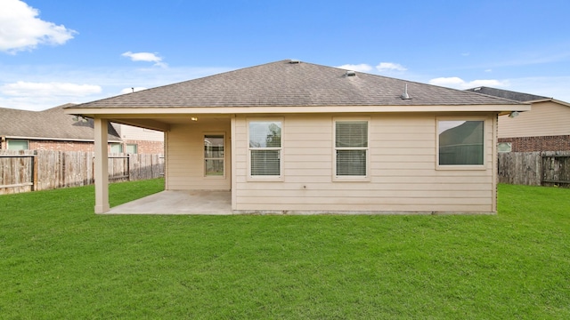 back of house with a yard and a patio area