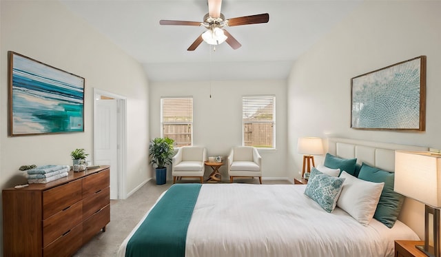 bedroom featuring ceiling fan, light carpet, and vaulted ceiling