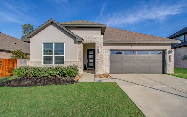 view of front of home with a front yard and a garage