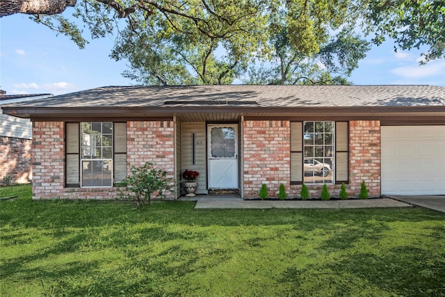 ranch-style home with a front lawn and a garage