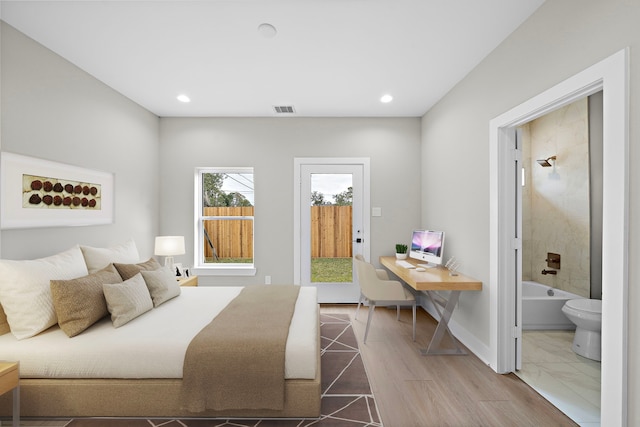 bedroom featuring hardwood / wood-style flooring and connected bathroom