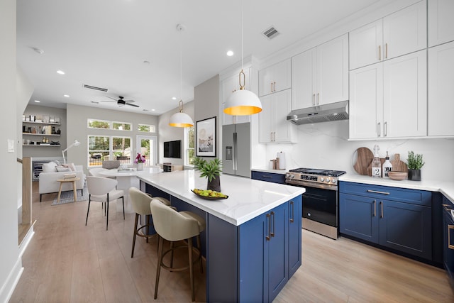 kitchen featuring ceiling fan, hanging light fixtures, stainless steel appliances, blue cabinets, and white cabinets