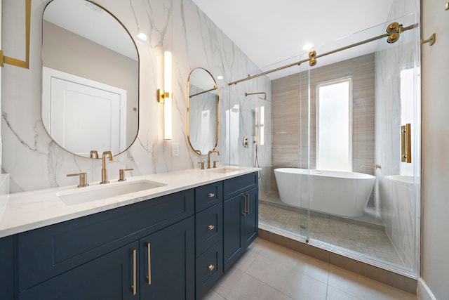 bathroom featuring tile patterned flooring, shower with separate bathtub, vanity, and tile walls