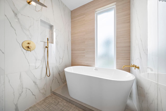 bathroom with tile patterned flooring, tile walls, and plus walk in shower