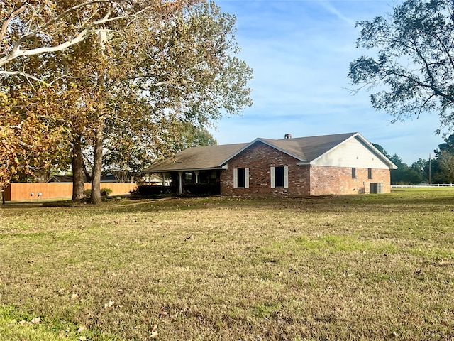 exterior space with central AC unit and a front yard