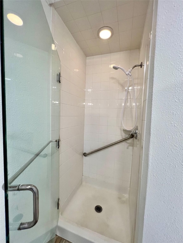 bathroom with a shower with shower door