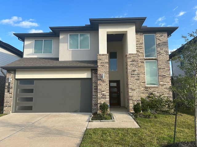 view of front facade with a garage and a front lawn