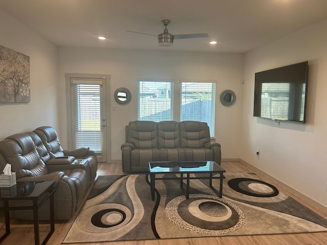 living room with plenty of natural light, ceiling fan, and light hardwood / wood-style flooring