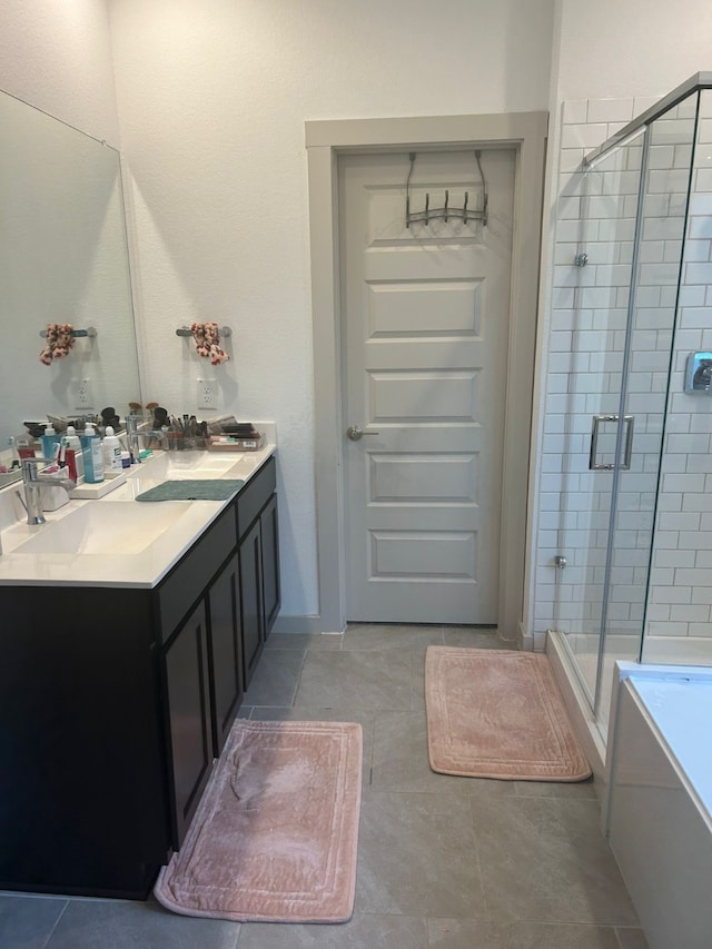 bathroom featuring tile patterned flooring, vanity, and plus walk in shower