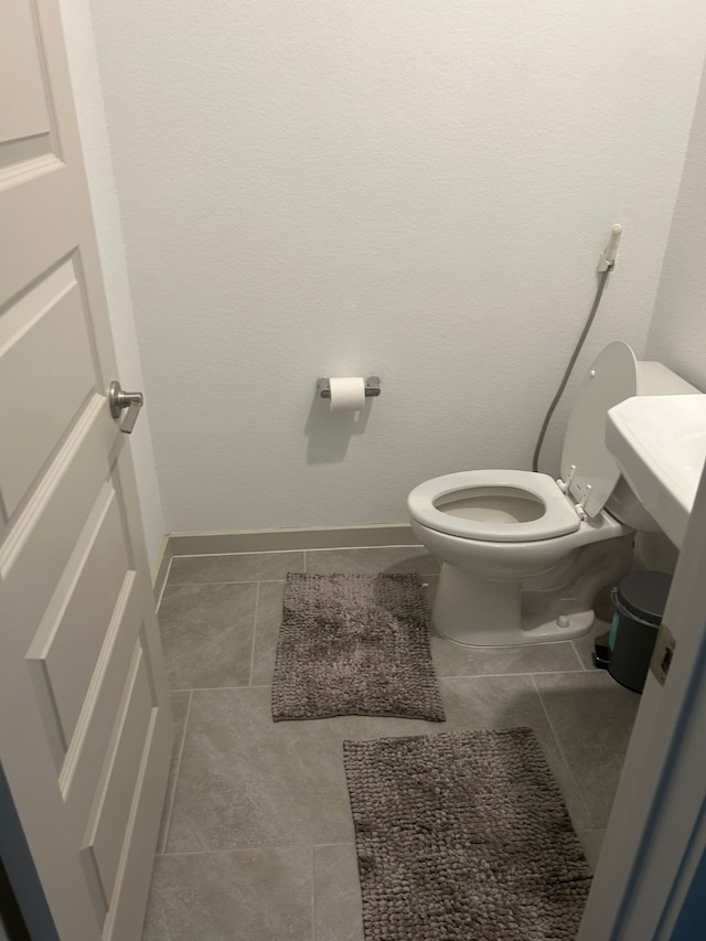 bathroom featuring tile patterned floors and toilet