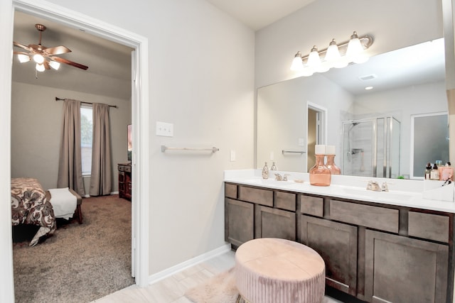 bathroom featuring vanity, ceiling fan, and an enclosed shower