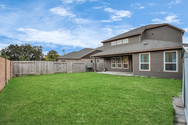 back of house featuring a yard and a patio