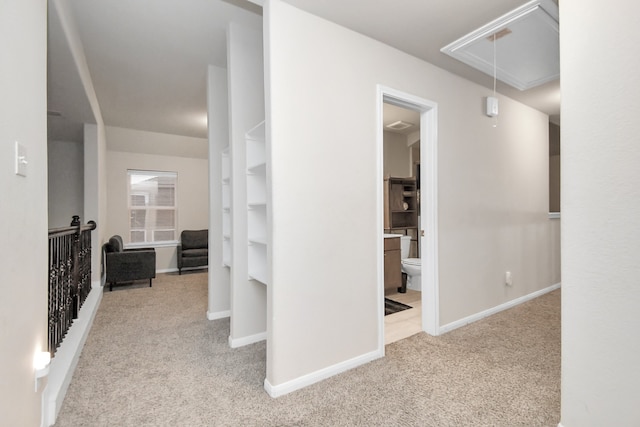 hallway featuring light carpet