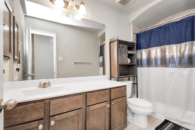 bathroom with toilet, a shower with curtain, vanity, and tile patterned floors