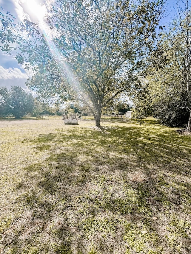 view of yard with a rural view