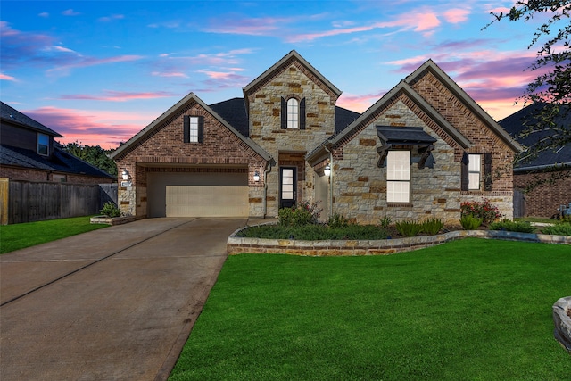 view of front of property featuring a lawn and a garage