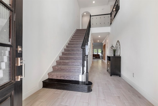 entryway featuring a high ceiling and light wood-type flooring