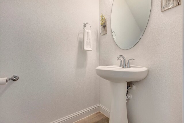 bathroom with hardwood / wood-style flooring