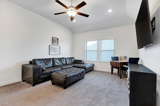 carpeted living room featuring ceiling fan and lofted ceiling