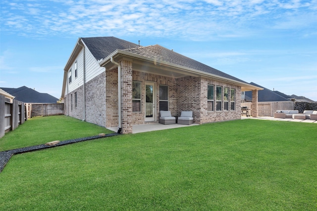 back of house featuring a yard, an outdoor hangout area, and a patio