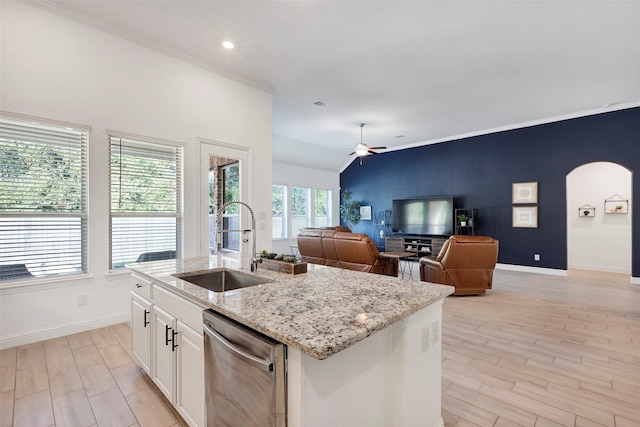 kitchen with white cabinets, a center island with sink, a healthy amount of sunlight, and sink