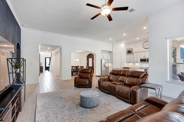 tiled living room featuring ceiling fan and crown molding