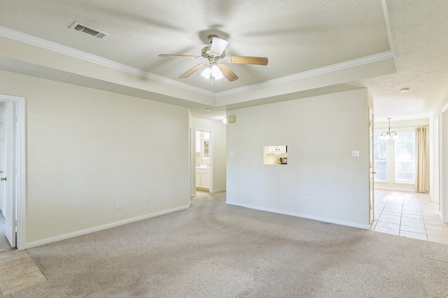 empty room featuring light carpet, a textured ceiling, and ornamental molding