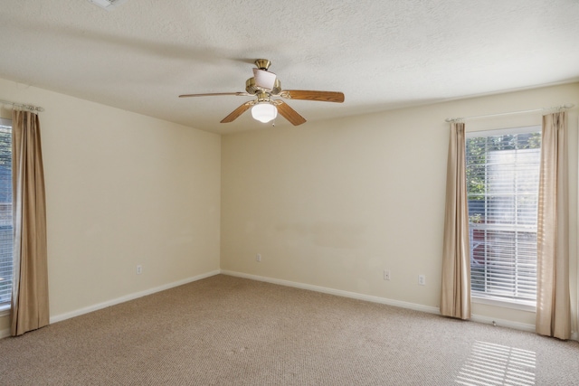 unfurnished room with light carpet, a textured ceiling, and ceiling fan