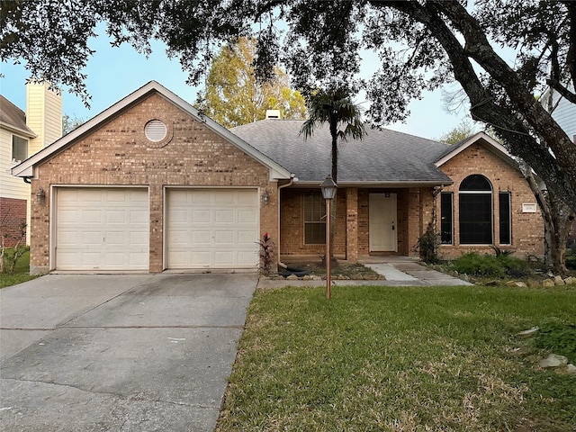 single story home with a front yard and a garage