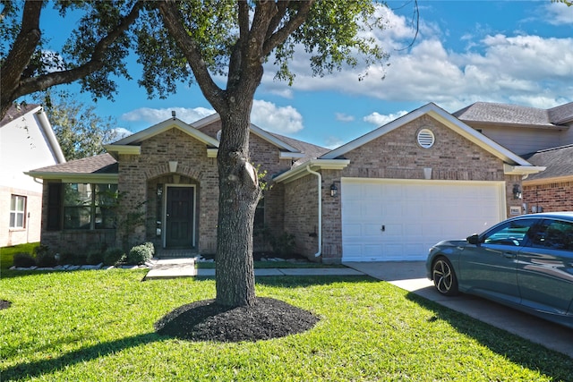 view of front of home with a front lawn and a garage