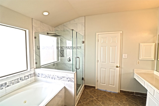 bathroom featuring tile patterned flooring, vanity, plus walk in shower, and vaulted ceiling