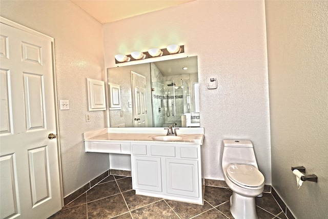 bathroom with tile patterned flooring, vanity, toilet, and a shower with shower door