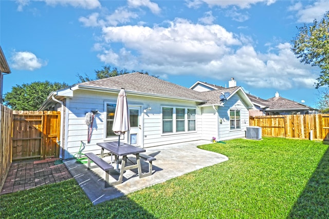 rear view of property featuring central air condition unit, a patio area, and a lawn