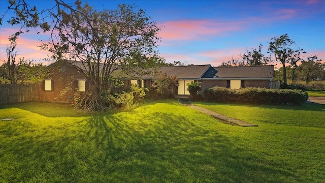 ranch-style house with a lawn