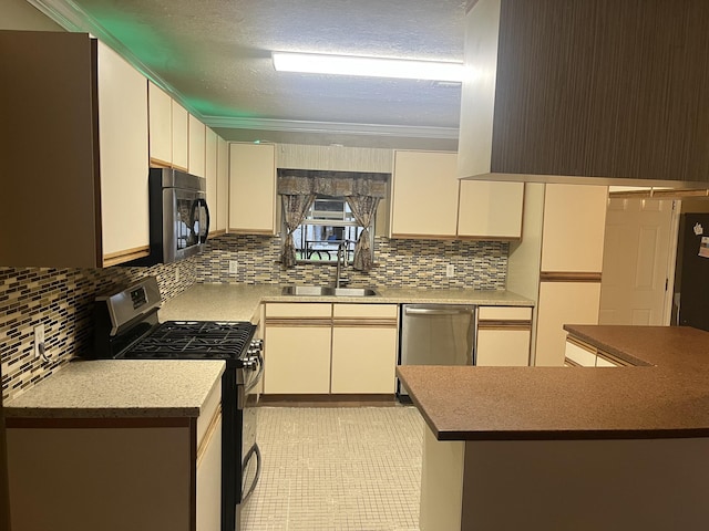 kitchen with sink, decorative backsplash, ornamental molding, appliances with stainless steel finishes, and white cabinetry