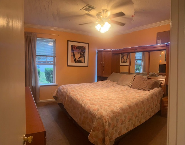 bedroom featuring ceiling fan, dark carpet, and ornamental molding