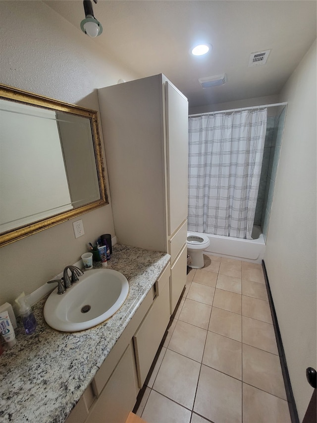 full bathroom with tile patterned floors, shower / bath combo, toilet, and vanity