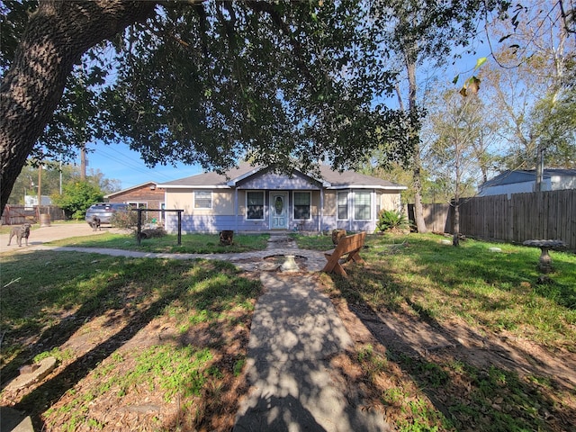 single story home with covered porch and a front yard