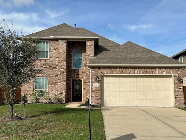 view of front facade with a front yard and a garage