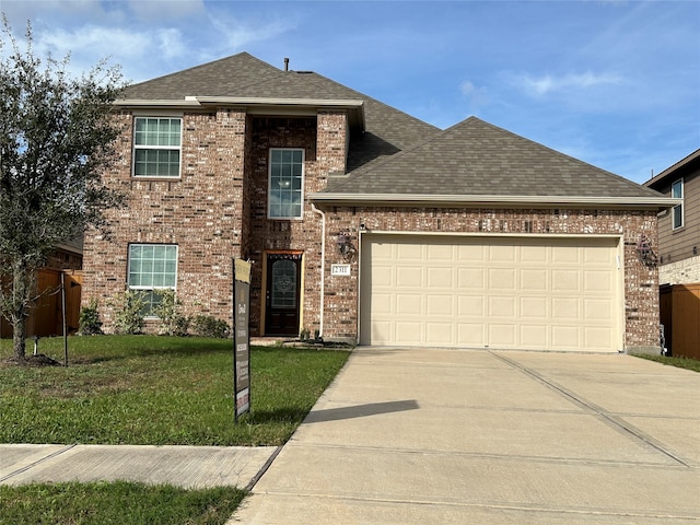 view of front of property with a front yard and a garage