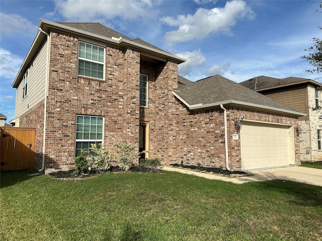 view of property featuring a garage and a front yard