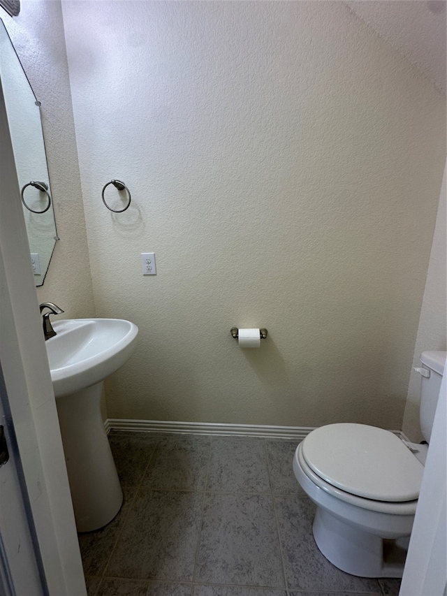 bathroom with tile patterned floors and toilet