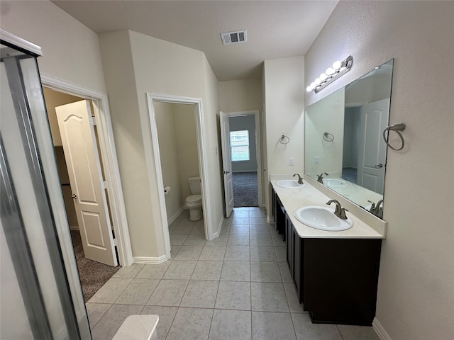 bathroom with tile patterned floors, vanity, and toilet