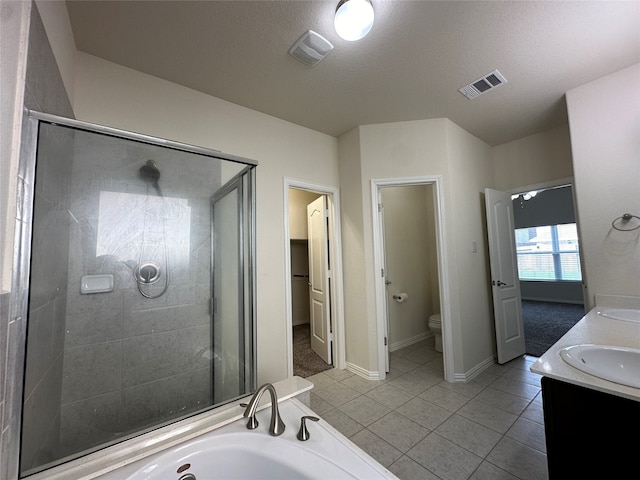 full bathroom with tile patterned floors, a textured ceiling, vanity, independent shower and bath, and toilet