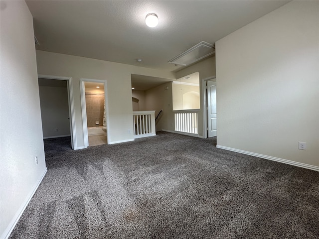 spare room with dark colored carpet