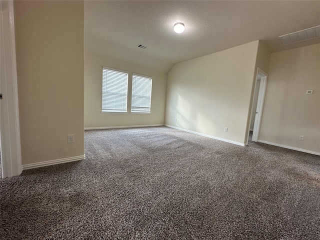 carpeted spare room with lofted ceiling