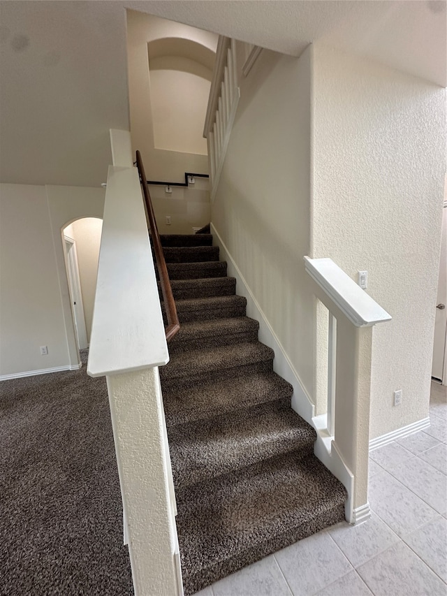 stairway with tile patterned flooring